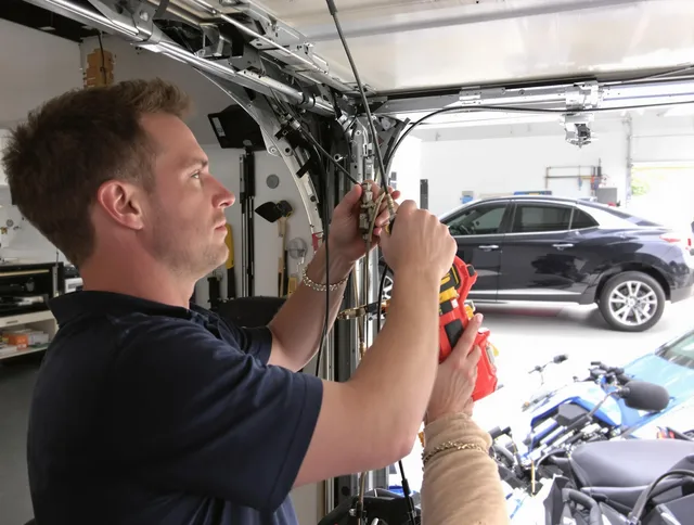 Tallmadge Garage Door Repair safety certified technician performing cable replacement in Tallmadge