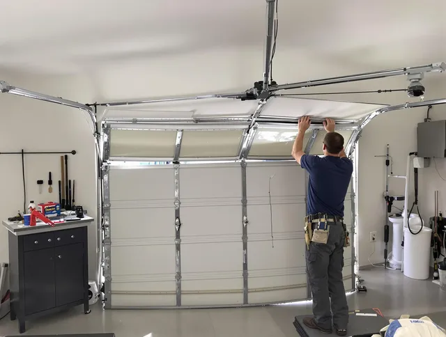 Tallmadge Garage Door Repair specialist performing precise section replacement on Tallmadge garage door